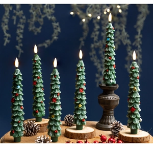 Detail of green Christmas tree LED candles with flickering flames and pinecone decor