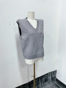 Detail view of the V-neck grey knitted vest top showing soft texture and premium stitching
