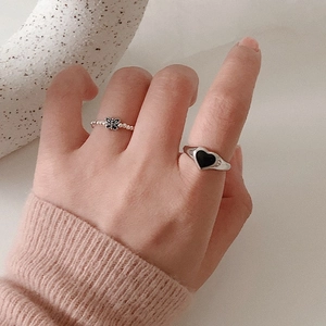 Minimalist S925 silver heart and butterfly ring set worn on hand with pink sweater