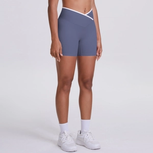 Detail view of crossover high waist design and smog blue fabric on athletic shorts