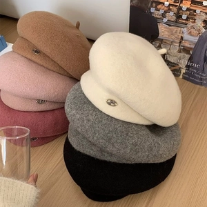 Chic British style wool beret for women in multiple colors with a metal logo detail