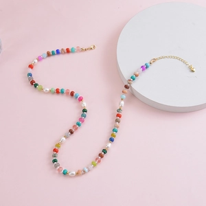 Bohemian colorful gemstone beaded necklace with freshwater pearls and a gold heart charm