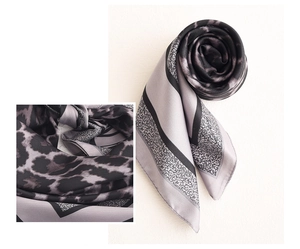 Detail view of 70cm silk-like scarf with grey leopard print and soft fabric texture