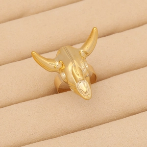 Macro shot of gold bull head skull ring displayed in a premium velvet jewelry box