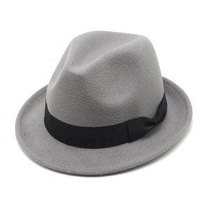 Detail view of a grey wool fedora hat with a black grosgrain ribbon and bow accent