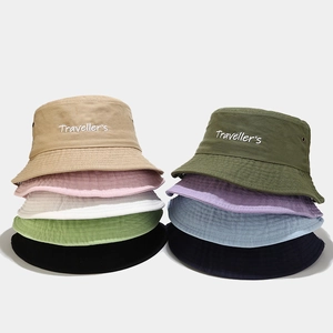 British style washed cotton bucket hat with embroidered Traveller's text in various colors
