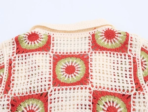 Close-up of crochet knit polo collar with colorful granny square floral patterns