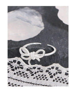 Close-up of S925 sterling silver stamp on bow-shaped irregular open ring for women