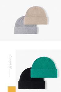 Detailed view of textured knitted fisherman hats in grey, beige, green, and black