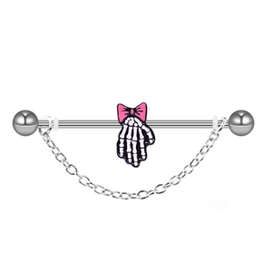 Macro detail of industrial barbell featuring skull hand charm with pink bow and chain