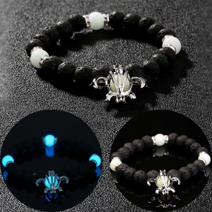Lava stone stretch bracelet with silver turtle charm and blue glowing beads in the dark