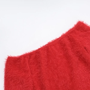 Close-up of high-density red faux fur fabric and detailed stitching on the sleeve edge