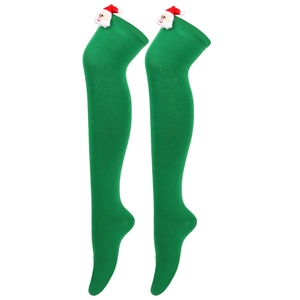 Detailed knit texture of green Christmas over-knee socks with Santa Claus 3D doll ornament