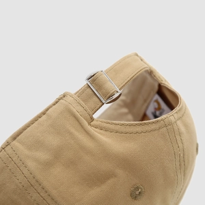 Detail of adjustable metal buckle and stitching on khaki cotton kids baseball cap