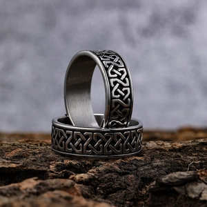 Vintage stainless steel Viking Celtic knot ring with silver finish on a bark base