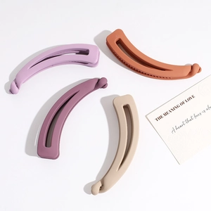 Matte banana hair clips in lavender, purple, orange, and beige colors on white background