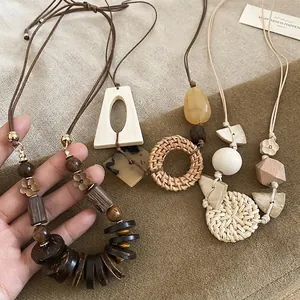 Bohemian geometric wooden bead and rattan circle pendant long necklace with earthy tones