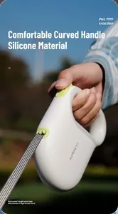 Detail of the ergonomic silicone handle on a white and green retractable dog leash