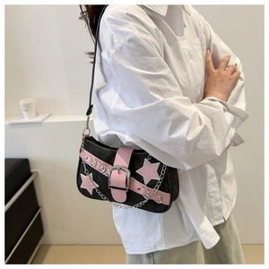 Detail of Y2K denim shoulder bag featuring pink leather star applique and metal buckle