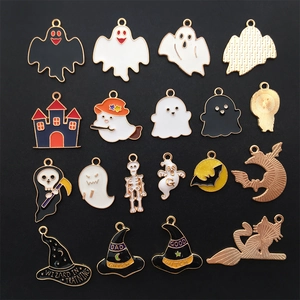 Macro view of assorted enamel Halloween charms featuring ghosts and wizard hats