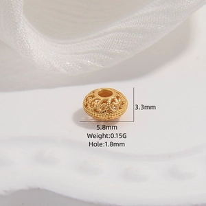 Detailed view of golden hollow filigree spacer bead with 3.3mm height and 5.8mm diameter