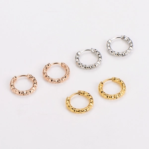 Three pairs of stainless steel hoop earrings with pyramid texture in gold, silver, and rose gold