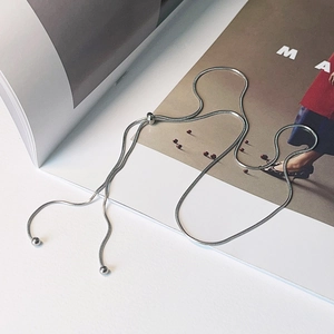 Detail of adjustable silver snake chain necklace with Y-shaped slide clasp and metal beads