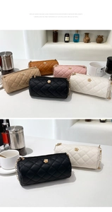 Detailed view of quilted cylinder bags with flower metal buckle and chain straps