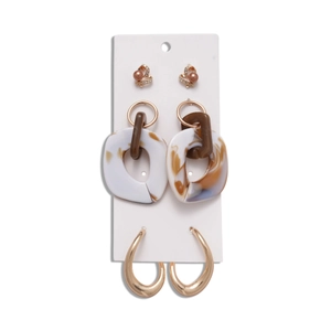 Set of six gold earrings with rhinestones, acrylic heart, and marble texture on display card