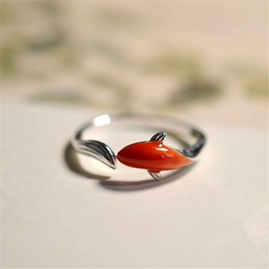 Macro detail of silver adjustable koi fish ring with vibrant orange enamel coating