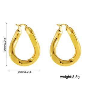 Detail showing 24mm gold hollow teardrop earrings with a twisted design and polished finish