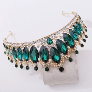 Ornate gold wedding tiara with emerald green crystals and sparkling rhinestones