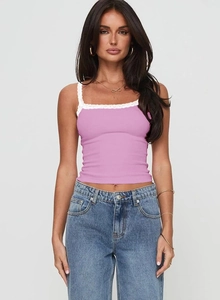 Detailed view of pink lace trim camisole paired with blue denim jeans in a trendy style