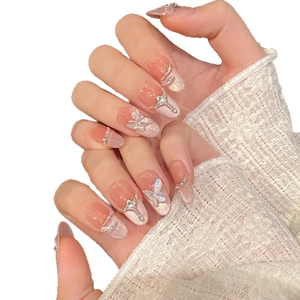 Sparkly butterfly press-on nails with 3D crystal accents and pink gradient finish