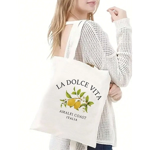 Detail of white canvas tote bag featuring Italian Amalfi Coast lemon print and sturdy straps