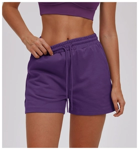 Detail of high-waisted purple sports shorts with drawstring and side pocket for women