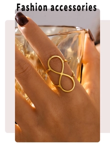 Macro shot of gold infinity PVD plated stainless steel adjustable ring worn on finger