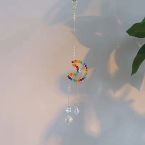 Detailed view of golden moon suncatcher with rainbow crystal beads and prism pendants