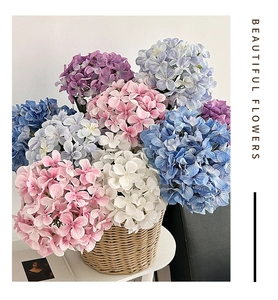 Artistic arrangement of multi-color 3D printed hydrangeas in a rustic woven basket