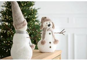 Close-up of plush Christmas snowman ornaments with branch arms and knit accessories