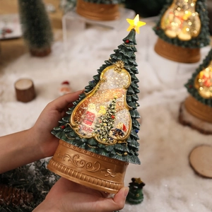 Lighted musical Christmas tree snow globe with Santa scene on bronze embossed base