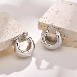 Polished silver stainless steel hollow U-shaped chunky hoop earrings on stone base