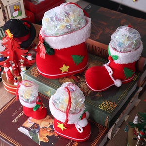 Detail of red flocked Christmas boots in four sizes with festive tree and star patterns