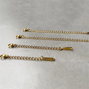 Set of four gold-plated stainless steel extender chains with lobster clasps and flat tags