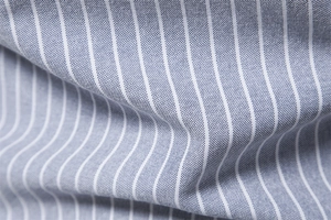 Macro view of blue and white striped cotton-linen fabric with detailed woven texture