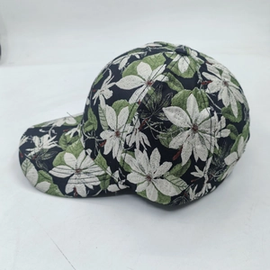 Detailed view of floral baseball cap featuring white flowers on black cotton fabric