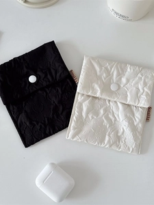Floral textured portable sanitary storage pouches in black and white with snap buttons