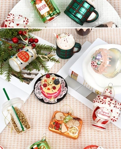 Detailed view of glass Christmas ornaments featuring cupcakes, drinks, and festive food designs