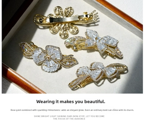 Macro detail of rose gold hair clips with white crystals and spring clasp mechanism