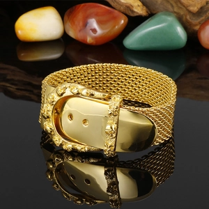 Gold stainless steel mesh belt bracelet with a punk skull buckle on a black reflective base